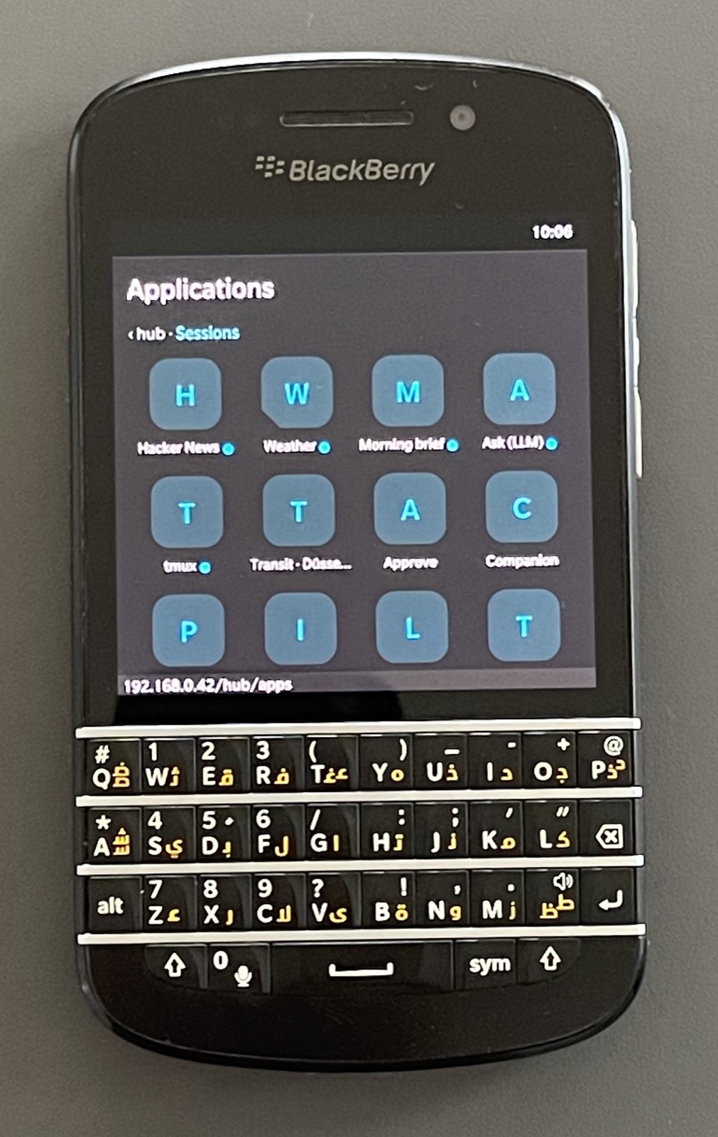 The BerryHub Applications grid on the Q10: Hacker News, Weather, Morning brief, Ask, tmux, Transit, Approve and Companion among the tiles.